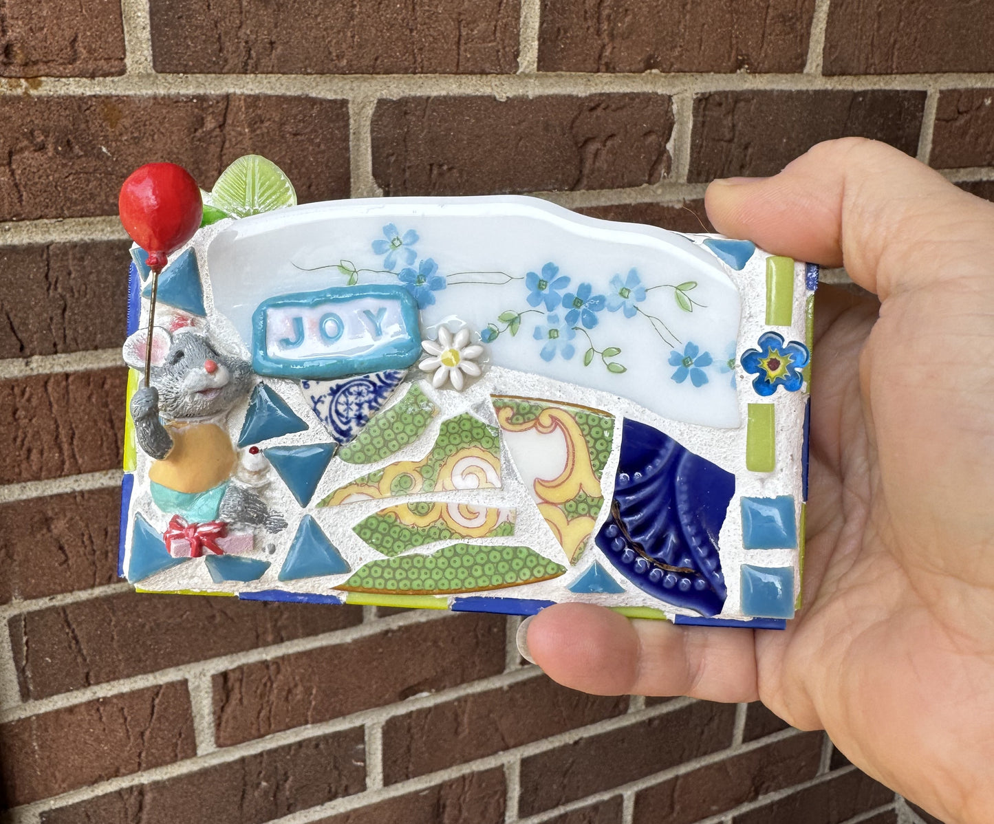 JOY mosaic with celebrating mouse, cupcake and red balloon