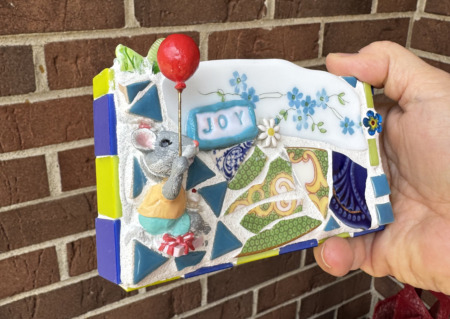 JOY mosaic with celebrating mouse, cupcake and red balloon